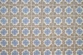 Old wall with traditional Portuguese decor tiles azulezhu in blue and brown tones on a beige background. Royalty Free Stock Photo