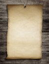 Old wanted paper or parchment pinned by nail to wooden wall Royalty Free Stock Photo