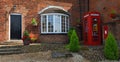 Old Post Office with Red Phone Box housing defibrillator and Red Letter box. Royalty Free Stock Photo