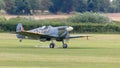 A vintage world war two British Spitfire fighter plane landing on airfileld Royalty Free Stock Photo