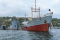 Old warships of the Russian Navy in the port of Sevastopol on the background of gray sky. Royalty Free Stock Photo