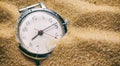 Old watch buried in sand Royalty Free Stock Photo