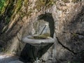 An old water fountain dug in the rock at the bottom of the Tamina Gorge near Bad Ragaz in Switzerland - 1