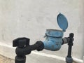 Old water meter with old wall background. Royalty Free Stock Photo