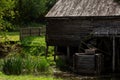 Old water mill made of wood with a wheel rotating from the flow of water Royalty Free Stock Photo