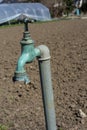 Old water pipe, Faucet with nature brown earth background A old rusty water tap in garden. Royalty Free Stock Photo