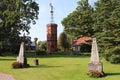 An old water pumping tower and two tombstone obelisks on the territory of Birini Manor in Latvia Autumn 2020