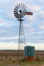 An old water pumping windmill with rainwater tank Royalty Free Stock Photo