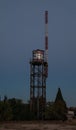 Old water tank with antenna and graffiti