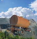 Old water tanker decaying at construction site. Rusted water container near a heap of concrete and cement. Abandoned old Royalty Free Stock Photo