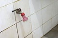 Old water tap in bathroom old faucet on a bathroom wall Royalty Free Stock Photo