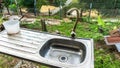 An old water tap and sink at the back of old building Royalty Free Stock Photo