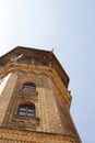 Old water tower building yellow brick wall European architecture tower top on blue sky background Royalty Free Stock Photo