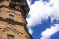 Old water tower made of ancient bricks on a background of blue sky with clouds Royalty Free Stock Photo