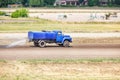 An old water truck is moistening a dirt treadmill for horses Royalty Free Stock Photo
