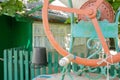 An old water well with a bucket in the garden, a metal handle for lifting water from the ground. Village well under the roof with Royalty Free Stock Photo