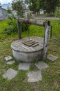 Old water well. Summer yard, rural scenery.