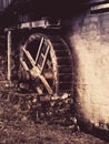 Old watermill wheel. Historical construction in rural region. Vintage style image