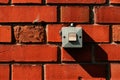 Old waterproof electricity switch mounted on house outer brick wall