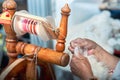 an old way of creating a woolen thread, a wooden spinning machine Royalty Free Stock Photo