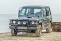 Old 4WD Mitsubishi Pajero car parked on a beach