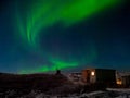 Old weather station. Winter Teriberka. Evening polar landscape with the Aurora Borealis