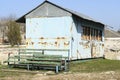 Old weathered abandoned blue tin house