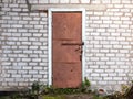 Old weathered barn door and brick wall. Royalty Free Stock Photo