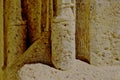 old weathered beige stone column detail. Romanesque style. porous stone texture. fine detail