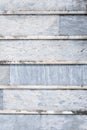 Old weathered blue gray stone wall with lichen with horizontal lines, as a textured background Royalty Free Stock Photo