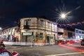 Old weathered building of Georgetown Penang at night with traffic lights