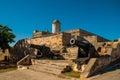 Old weathered cannons and shots exposition near the walls of Jagua fortress Fortaleza de Jagua. Cienfuegos, Cuba.