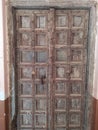 Old weathered carved traditional door of building in Stone TownPali