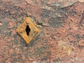 Old weathered chappy door with rusty keyhole