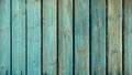 Old weathered and distressed wooden panels with traces of teal green paint