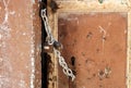 Weathered door of an abandoned house locked with chain and a rusty padlock Royalty Free Stock Photo