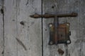 Old weathered door with rusty doorlock