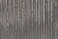 Old weathered faded shed wall made from vertically oriented wood boards. Vintage rustic textured timber background. Lumber texture Royalty Free Stock Photo