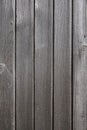 Old weathered faded barn wall made from vertically oriented wood planks. Vintage rustic timber background. Lumber texture Royalty Free Stock Photo