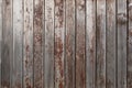 Old weathered faded shed wall made from vertically oriented wood boards. Vintage rustic textured timber background. Lumber texture Royalty Free Stock Photo