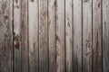 Old weathered faded shed wall made from vertically oriented wood boards. Vintage rustic textured timber background. Lumber texture Royalty Free Stock Photo