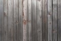 Old weathered faded shed wall made from vertically oriented wood planks. Vintage rustic textured timber background. Timber texture Royalty Free Stock Photo
