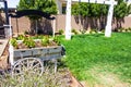 Old Weathered Flower Cart In Rear Yard With Swing Set Royalty Free Stock Photo