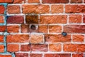 An old weathered fragment of a brick wall with cracks and round holes. Background for the designer. A large brick