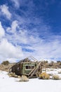 Old weathered Ghost Town buildings in the desert during winter with snow. Royalty Free Stock Photo