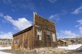 Old weathered Ghost Town buildings in the desert during winter with snow. Royalty Free Stock Photo