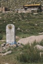 Old and weathered grave with a buddhist temple in the background in Mongolia Royalty Free Stock Photo