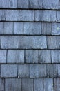 Old weathered gray clapboard shingles on cottage at beach