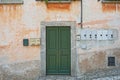 Old weathered grunge house. Green wooden door Royalty Free Stock Photo