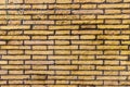 Old and weathered grungy yellow brick wall as seamless pattern texture background Royalty Free Stock Photo